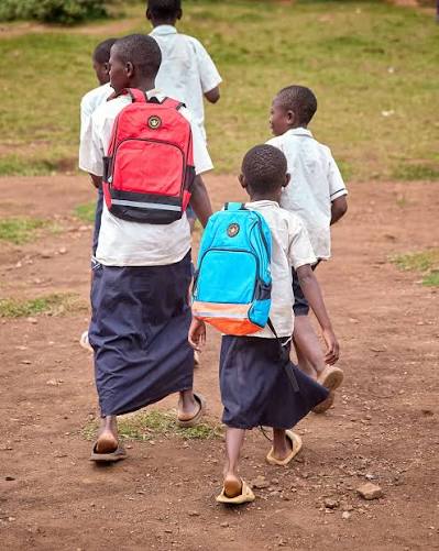 Children walking to school with backpacks