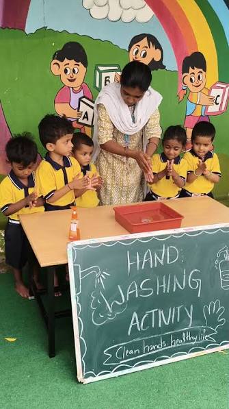 Teacher leading handwashing activity with young children