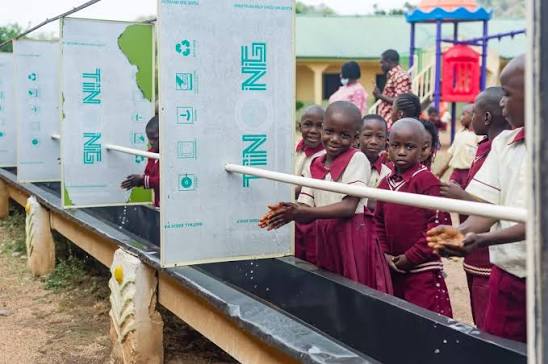 School children washing hands at hygiene stations
